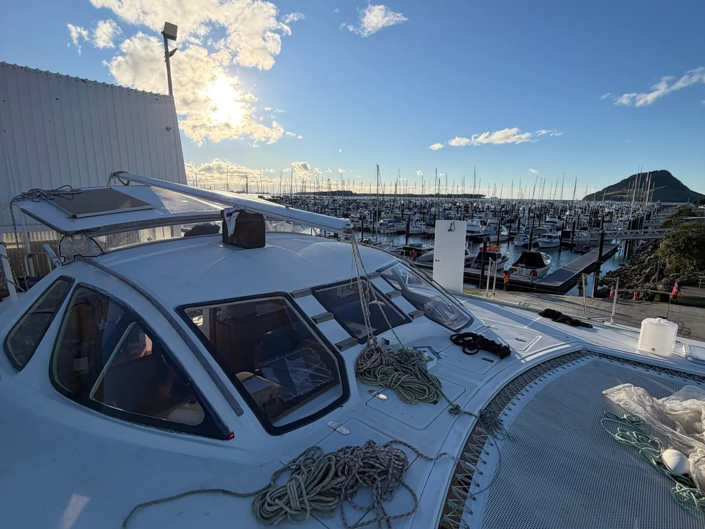 A launch moored at the Tauranga marina with Mauao in the background